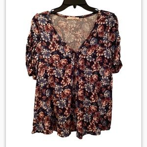 Floral short sleeved v neck top with rouching on the shoulders.